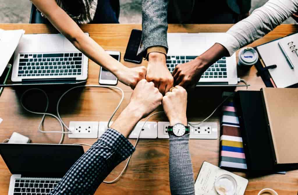 Team at desk fist bump