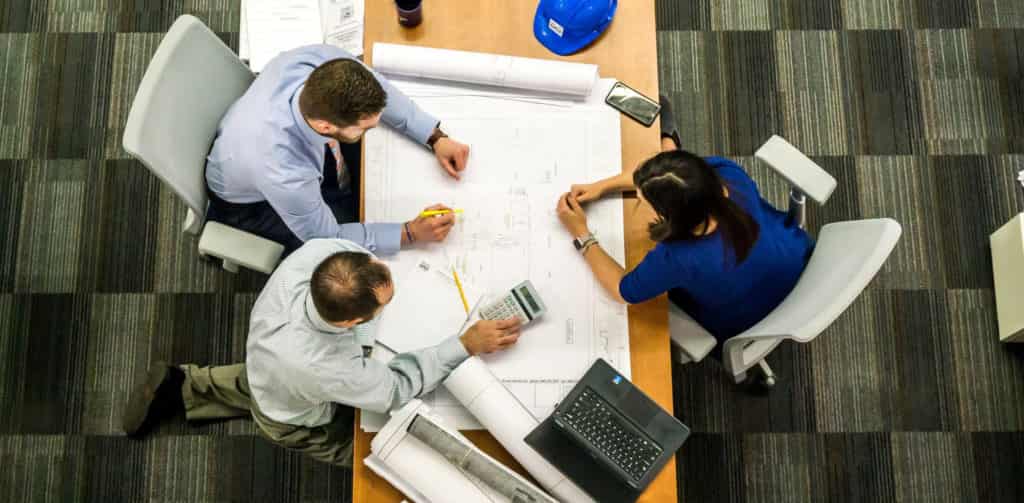 Professional workers sitting around desk