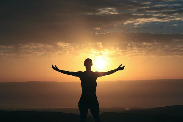 Yoga pose with sun rise in background