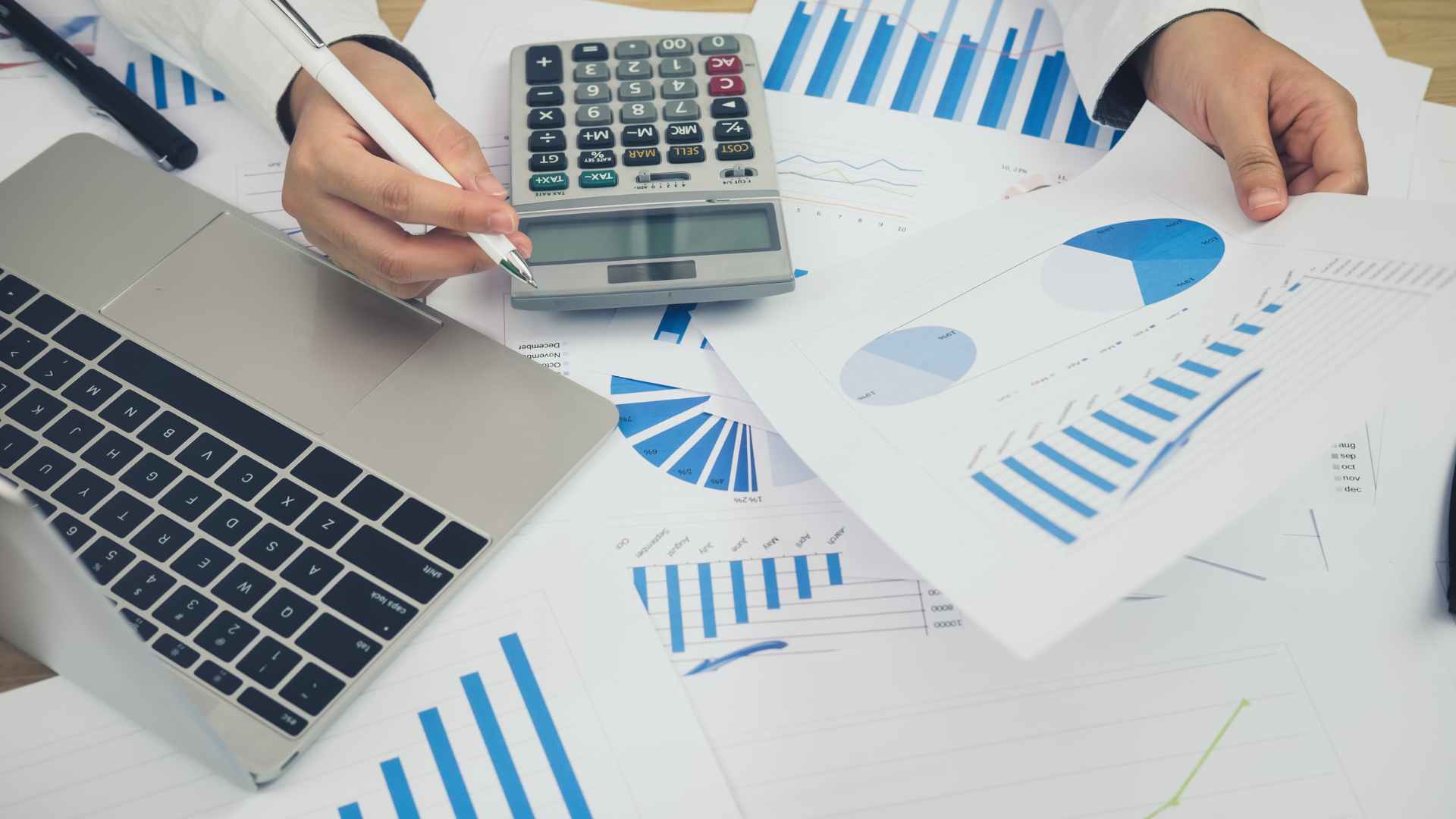 person working at desk with financial papers